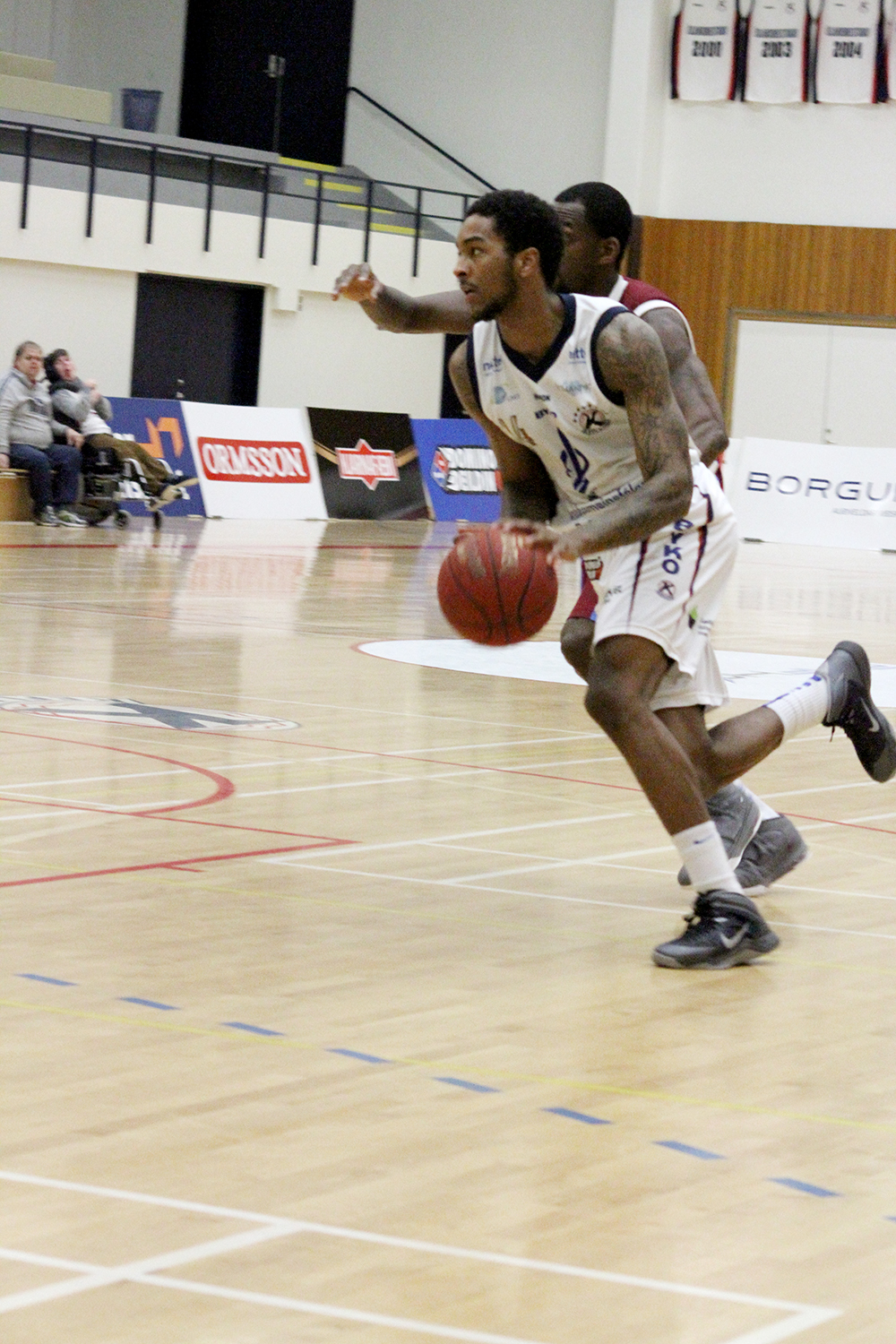 men on opposing teams playing a game of basketball