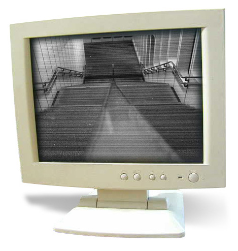 an old white computer monitor with its reflection in a mirror