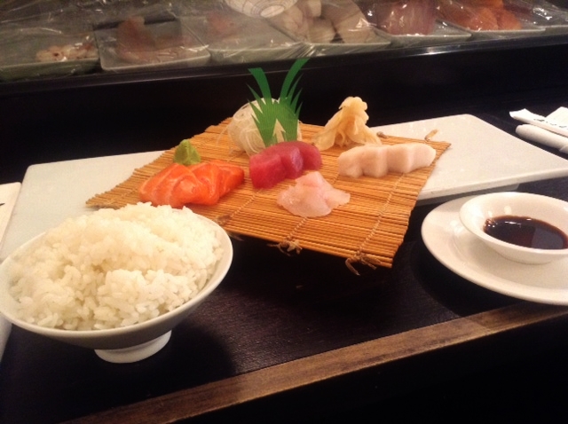 rice and sashimi displayed on a table