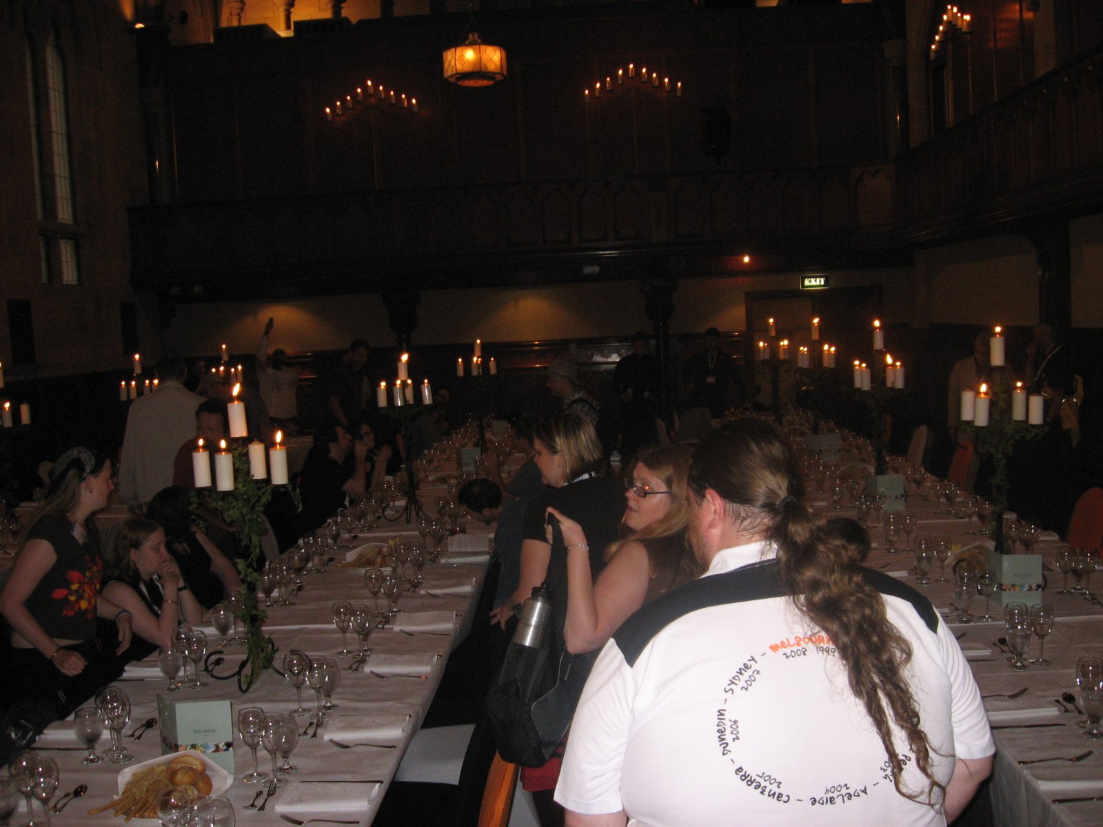 several people sitting at tables in a banquet hall