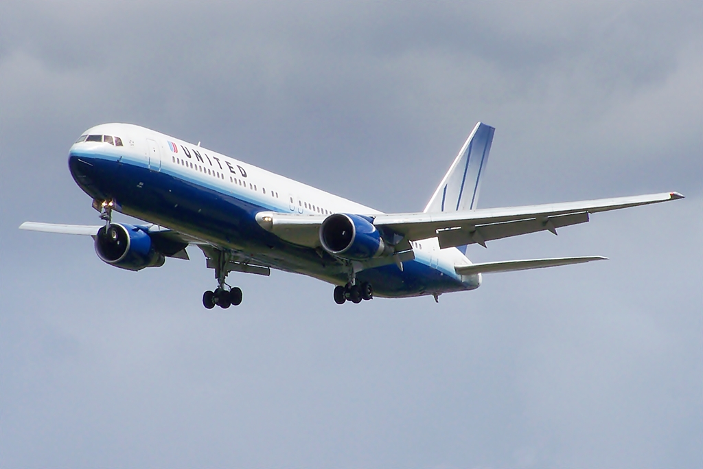 a large jetliner flying through a cloudy sky