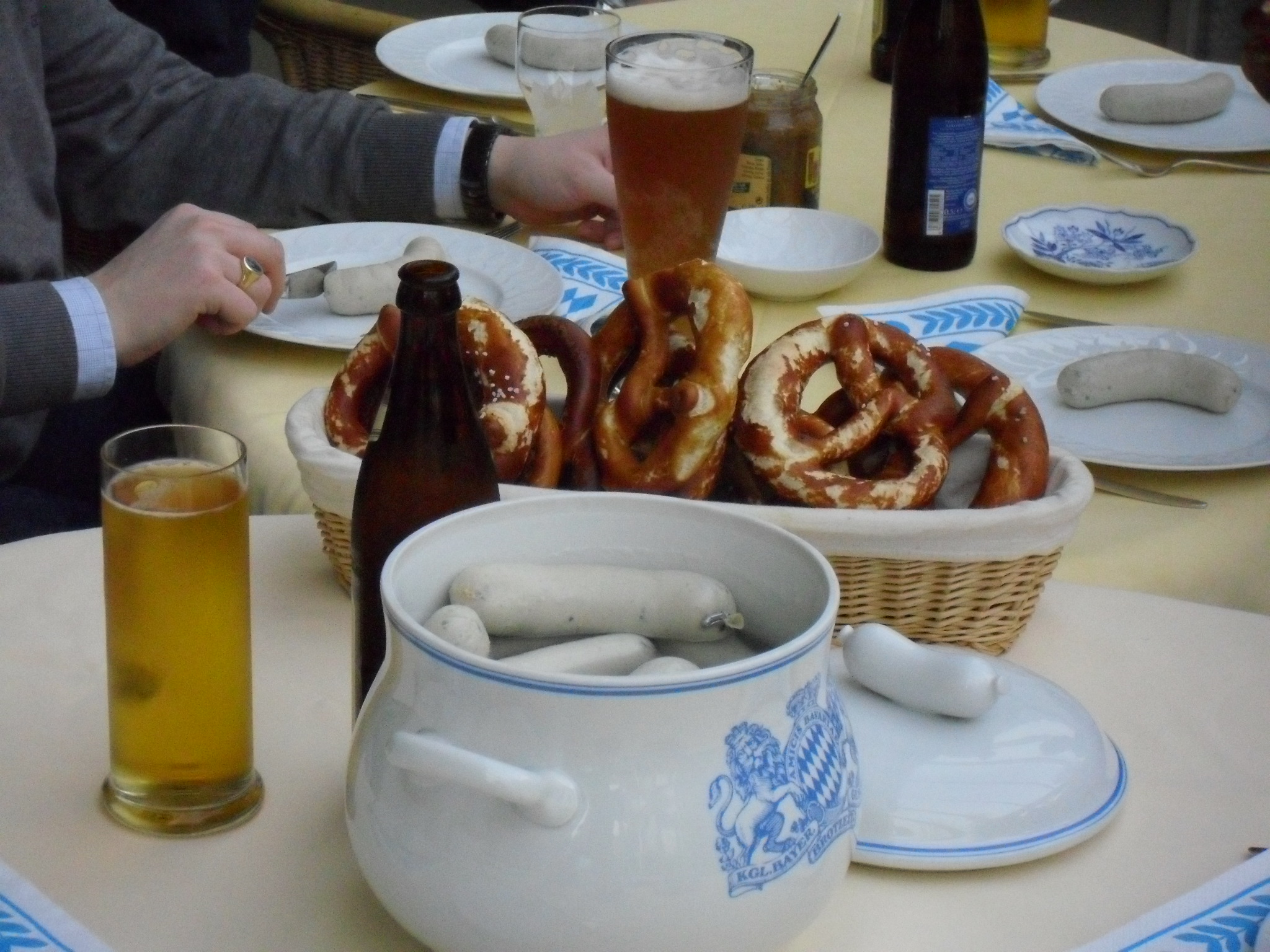 people sitting at a table with plates and glasses of beer