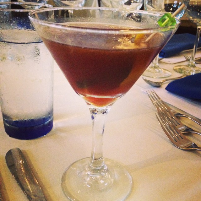 a small martini glass sitting on top of a white table