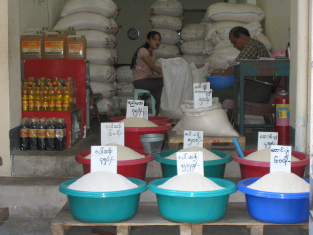 a person selling rice at the market place