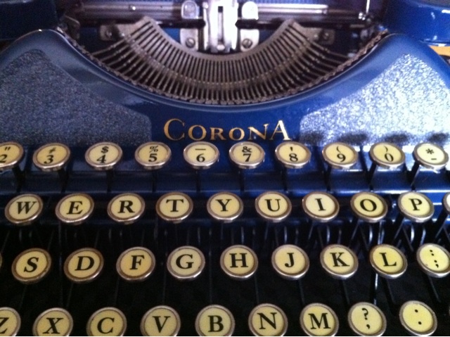 a close up of an old - fashioned blue typewriter with the word corona printed on the side