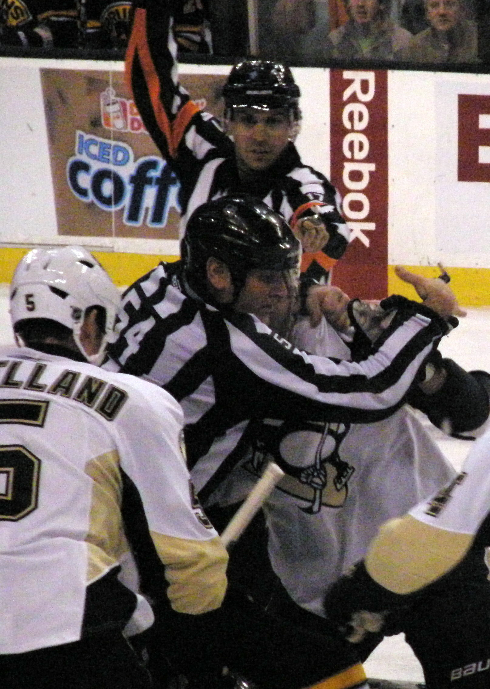 some hockey players are playing on the ice