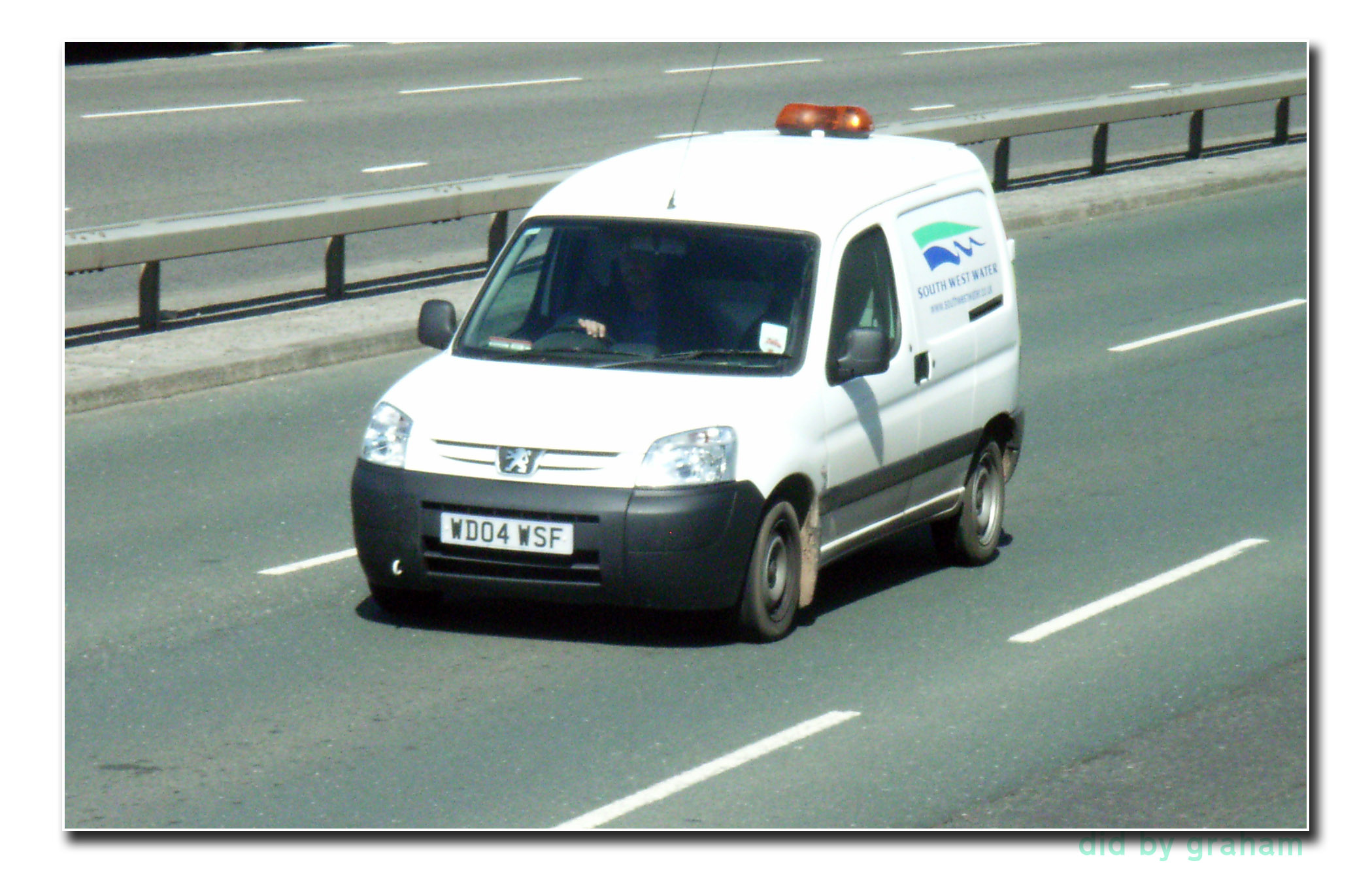 a van driving on a highway with lights on