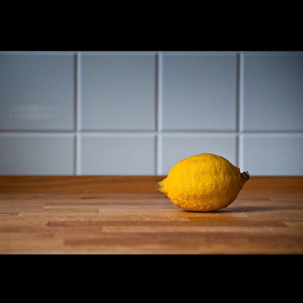 a lemon sitting on top of a wooden counter