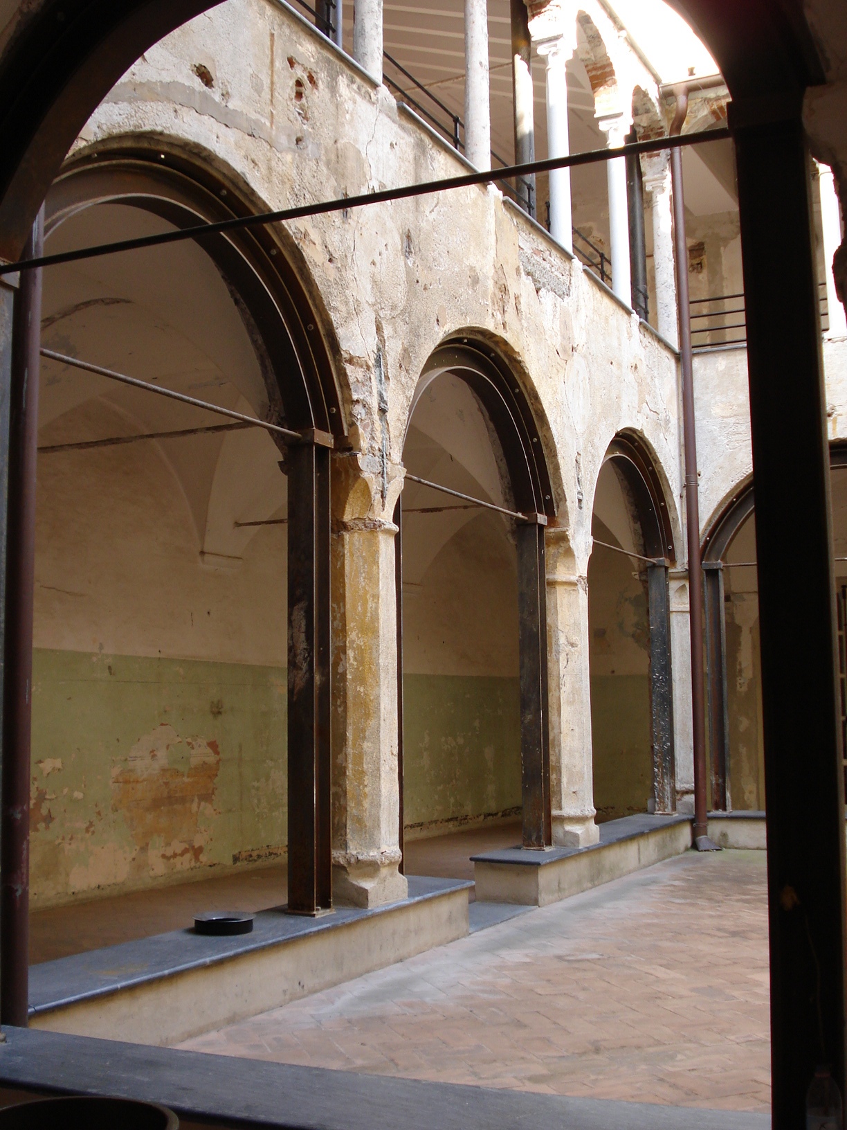 an arch in a building next to two benches