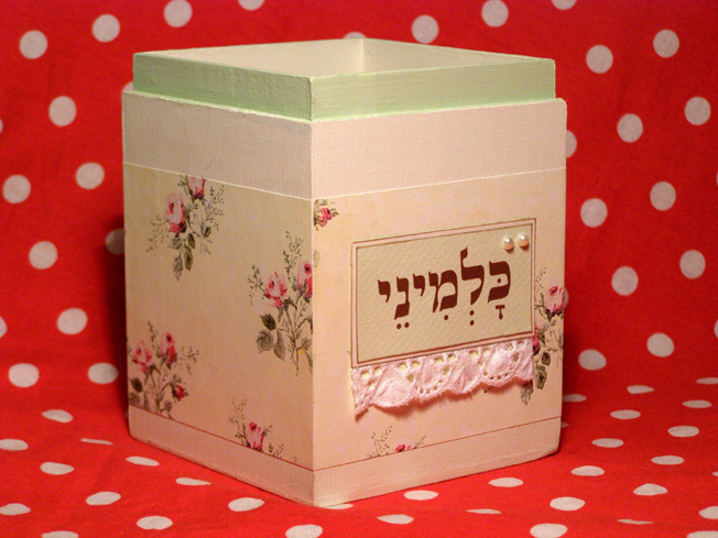 there is a small square box decorated with flowers and dots
