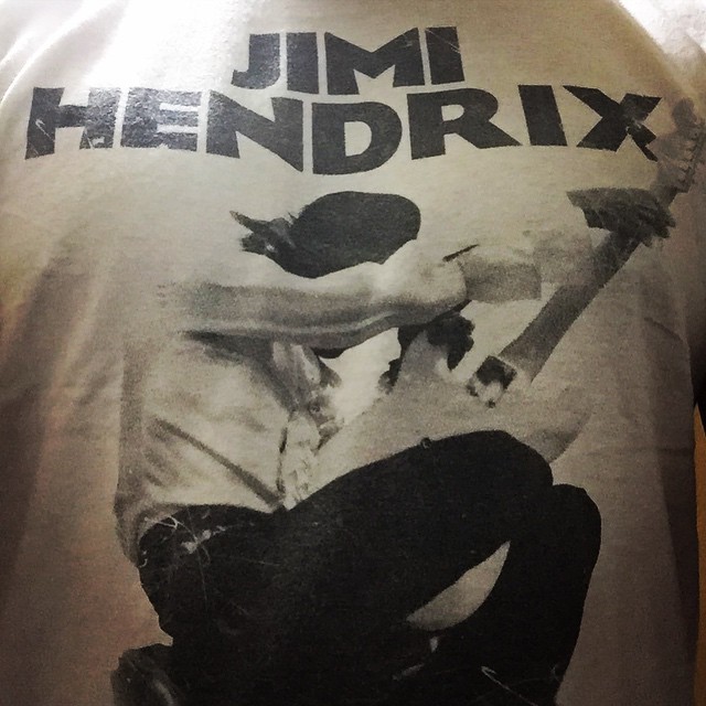 the back view of a t shirt with a poster of a man on it