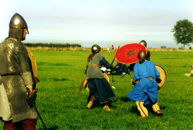 some medieval knights getting ready to battle in a grassy field
