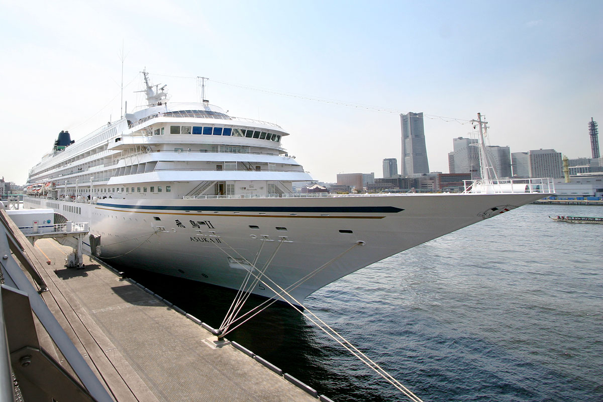 a large white ship in the middle of a harbor