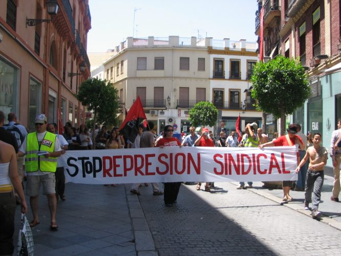 a protest in the street with people holding signs