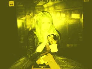 a woman with blonde hair is holding a drink and some food