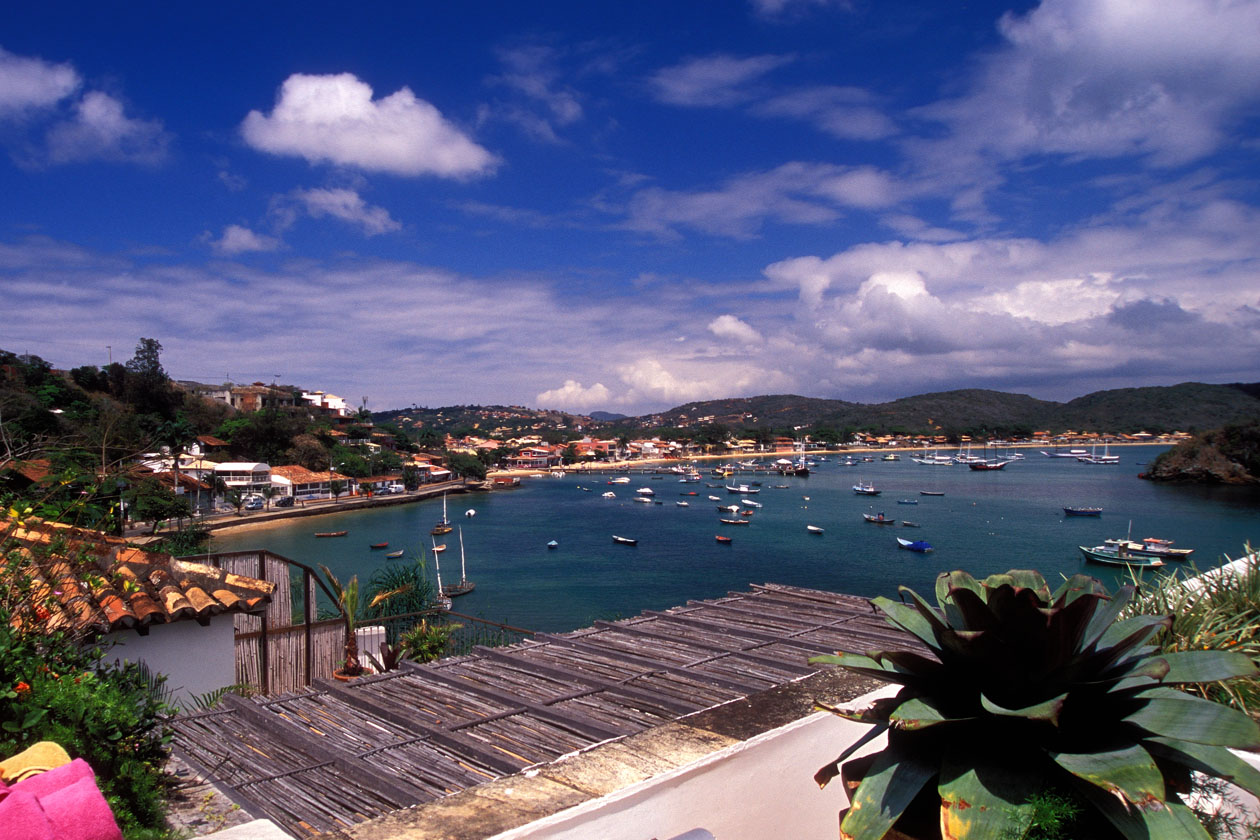 boats in the water and some houses on the shore