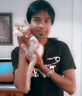 a young person holding a cat in their hands