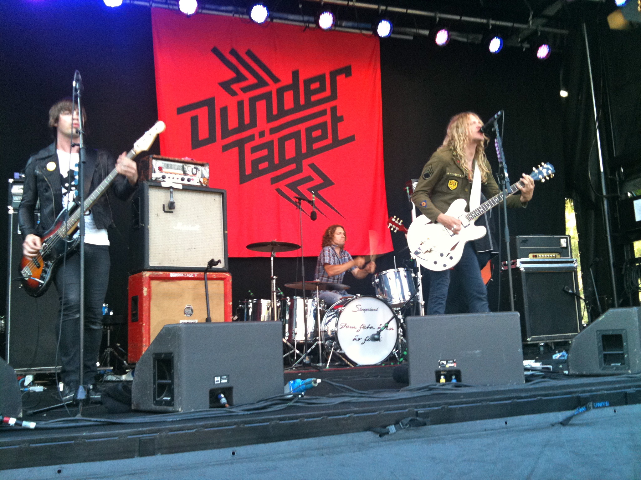 a group of musicians playing instruments on stage