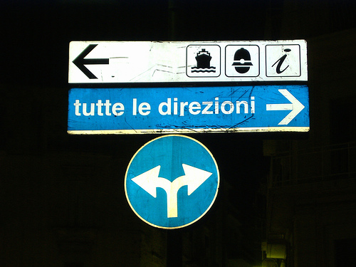 a street sign is lit up by a dim light