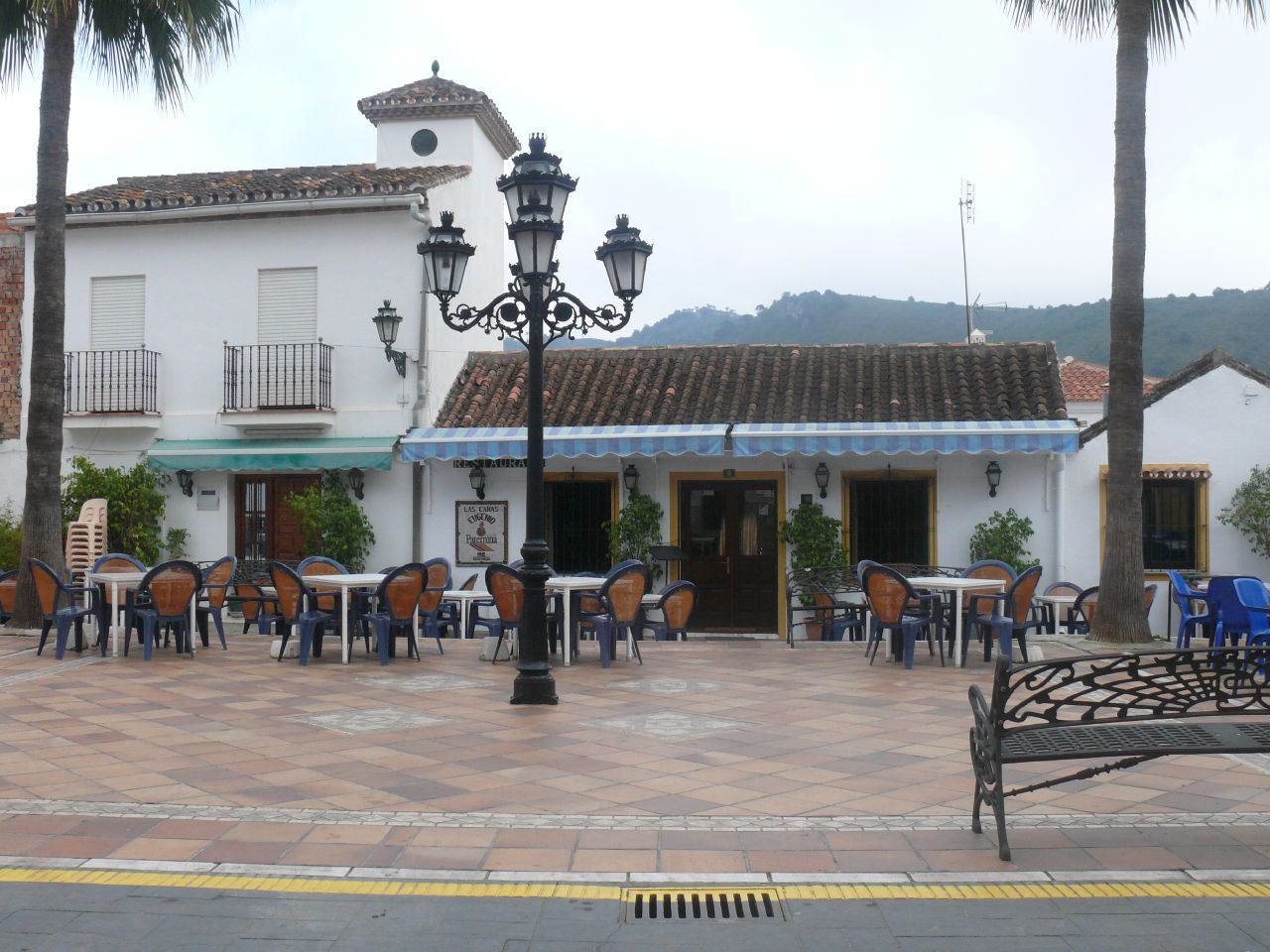 some tables are shown outside and on the side walk