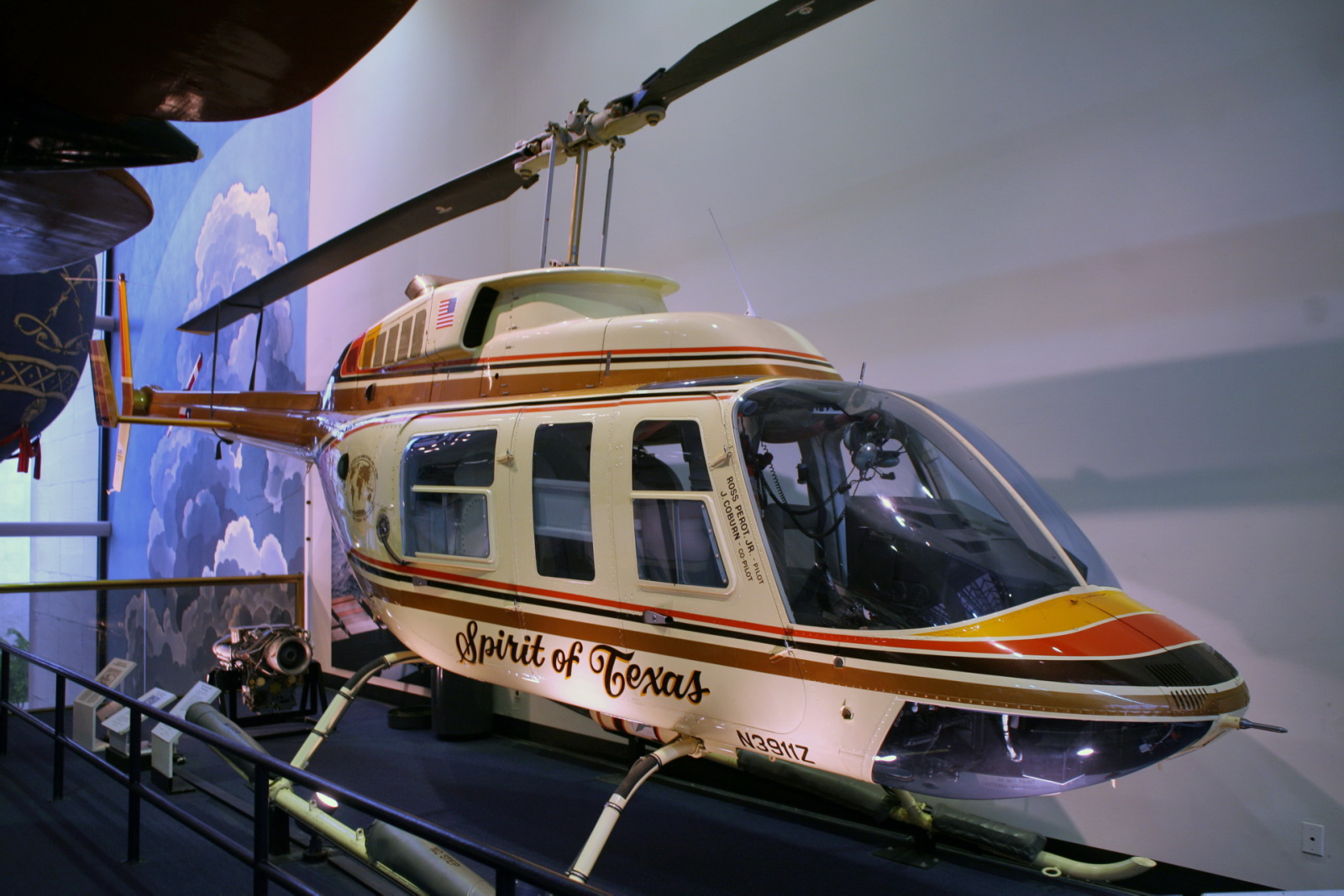a museum display with a helicopter displayed on a platform