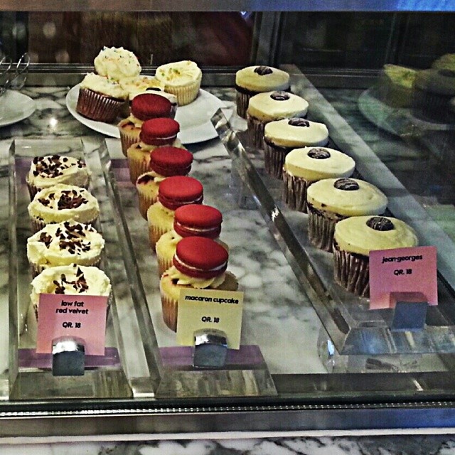 a variety of different kinds of cupcakes on a display