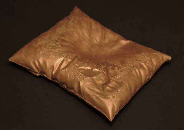 a square cushion with a golden metallic design