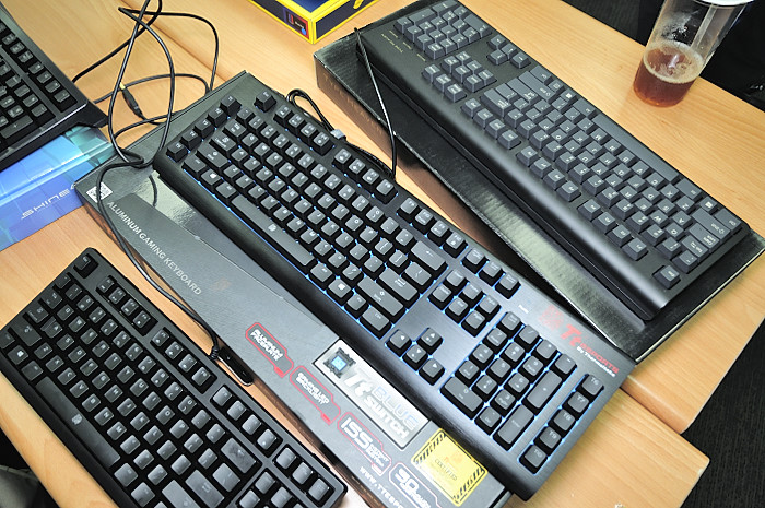 two keyboards are placed on a brown table