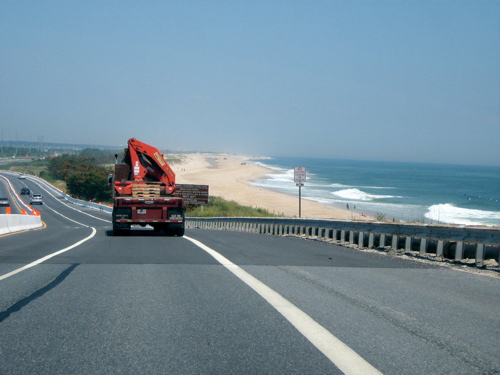 the red truck has been driving on a beach