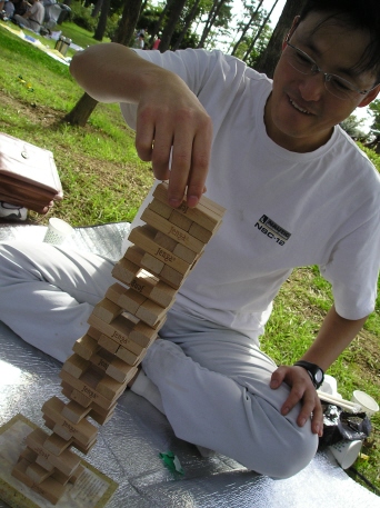 a man playing with wooden blocks in the park