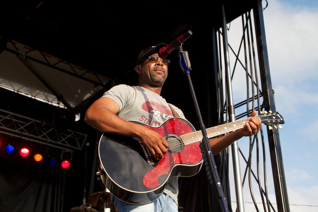 the guitar player is at a concert on stage