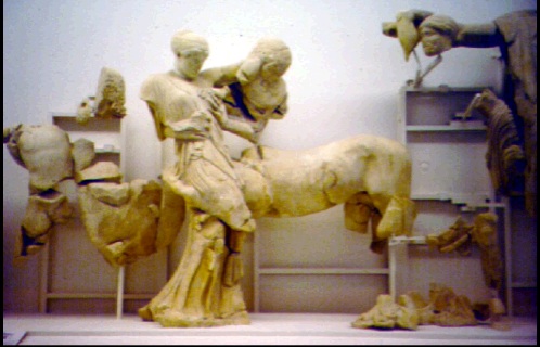 several sculptures with people sitting on horses