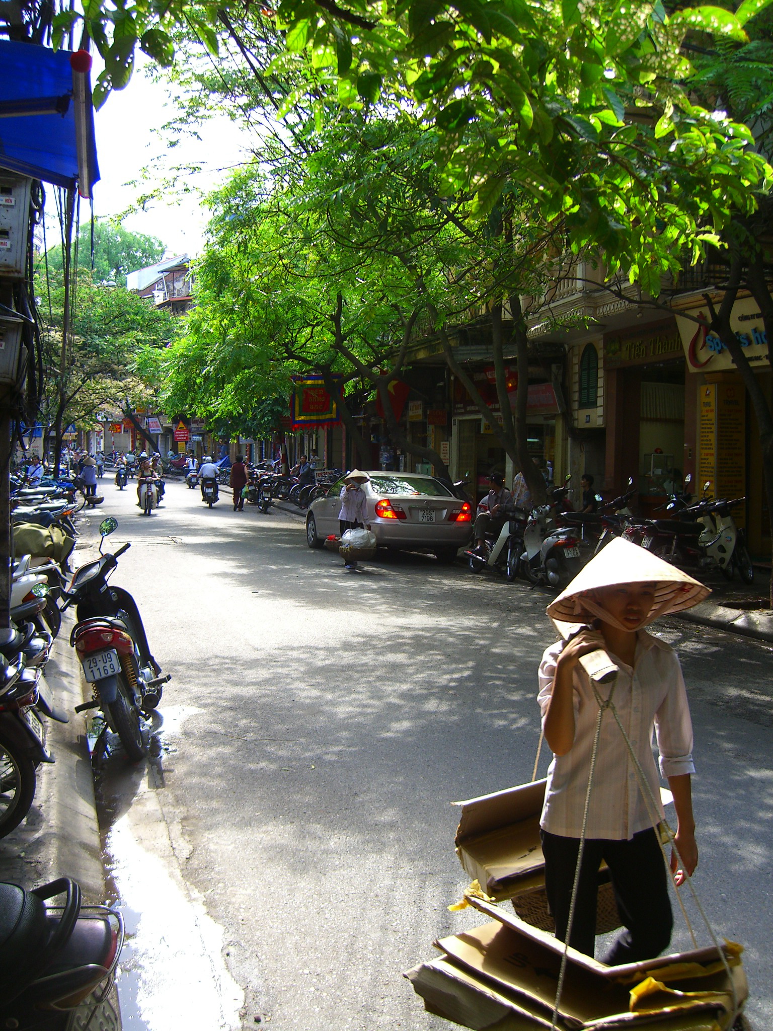 a person is carrying a small boat down a road