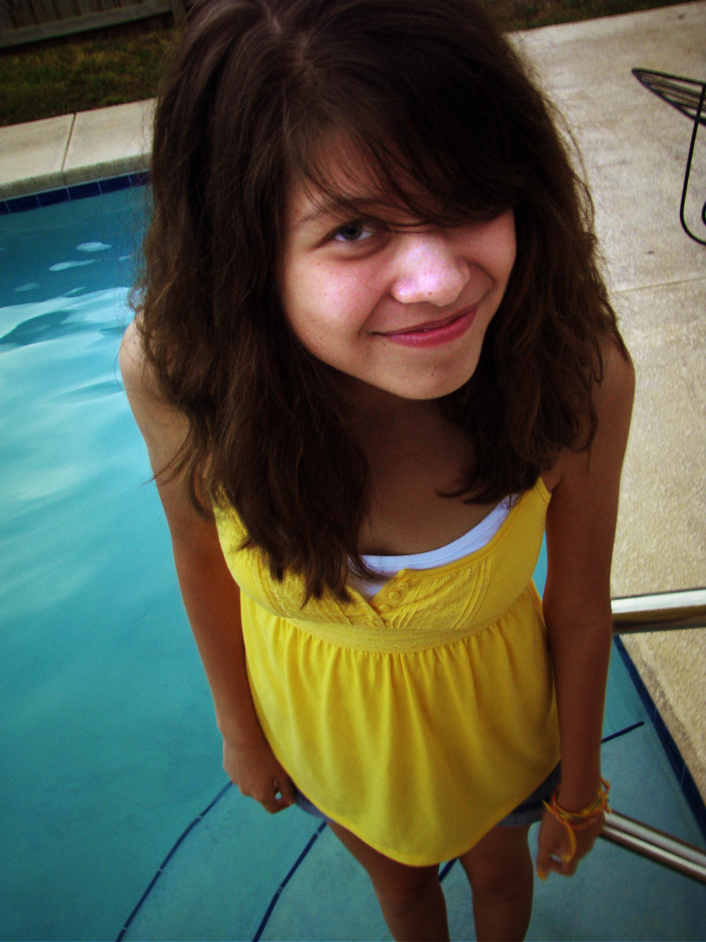 a  smiling next to a swimming pool