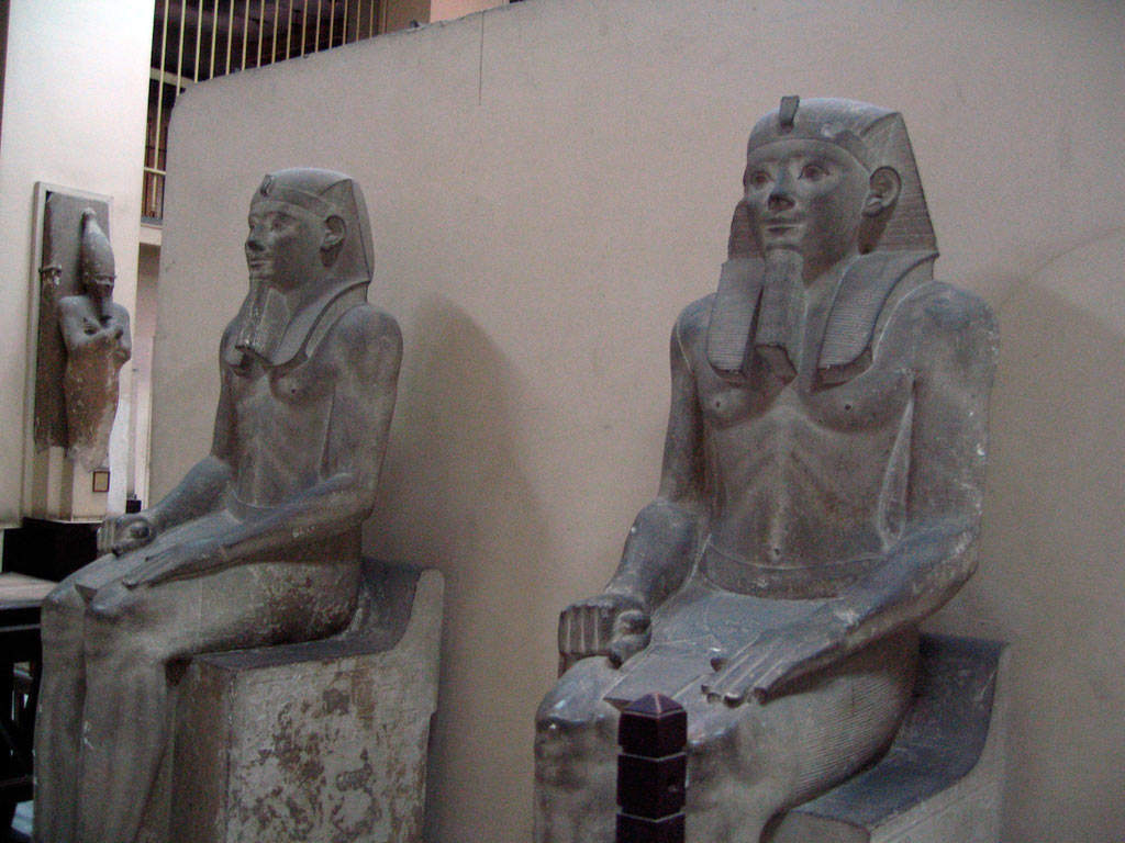 two statues of pharaohs sitting next to each other