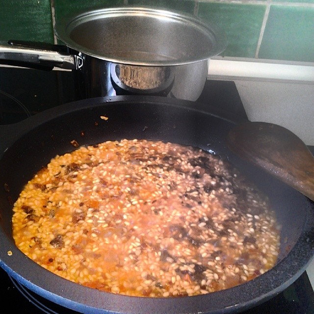 a big pan on top of a stove next to some food