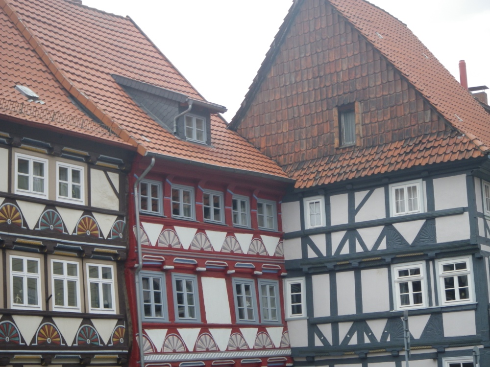 three buildings with windows and a tiled roof