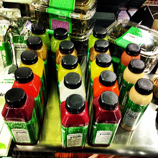 a number of bottles with different colored lids on the shelf