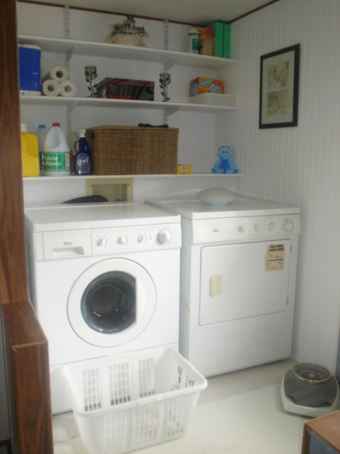 a kitchen filled with white appliances and a washer