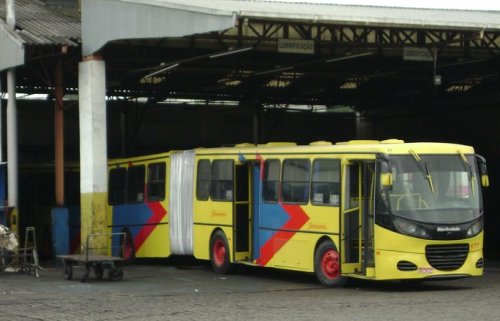 a yellow and blue bus parked in a lot