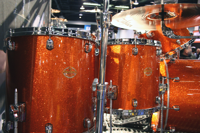 a close up of an orange sparklely drum set