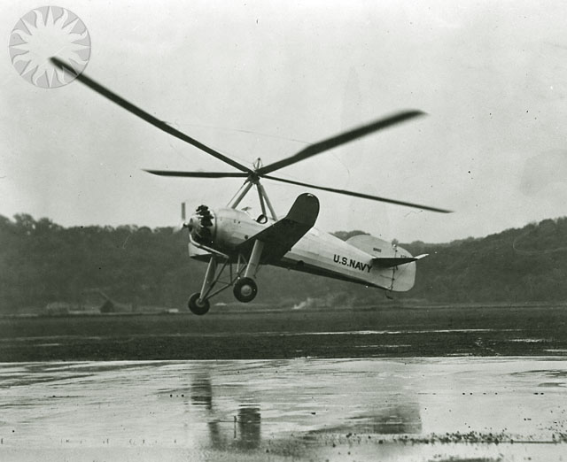an old black and white po of a helicopter over water