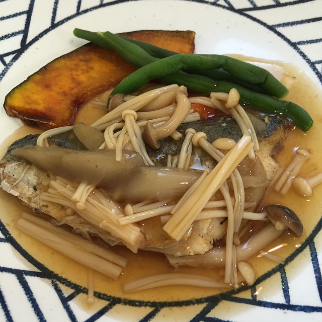 a plate of asian food is on a patterned tablecloth