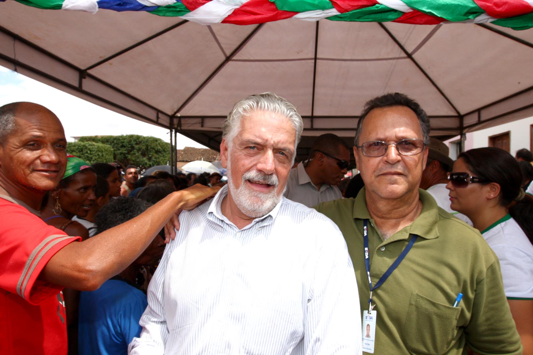 there are three men standing together and posing for the camera