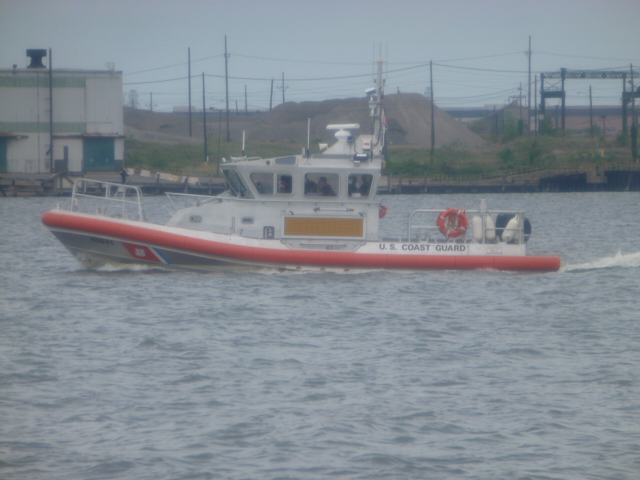 a red and white boat driving through the ocean