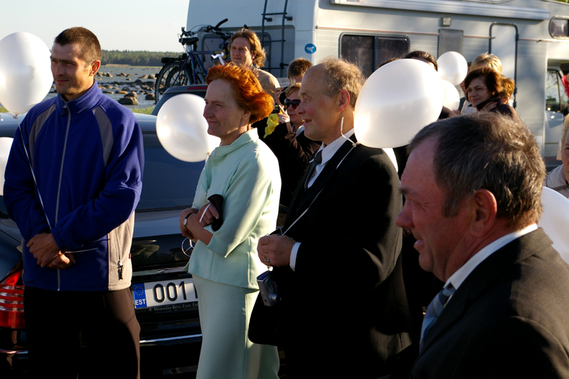 several people are dressed in formal clothes and balloons