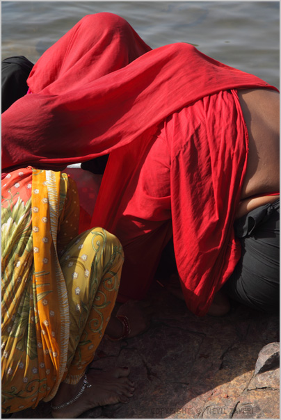 a woman in a red cloth laying down