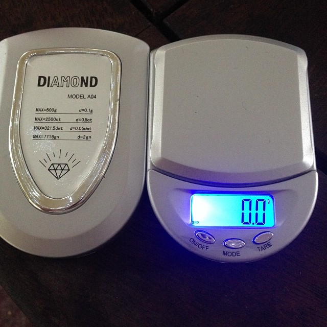 a clock and an automatic thermometer sitting on a table