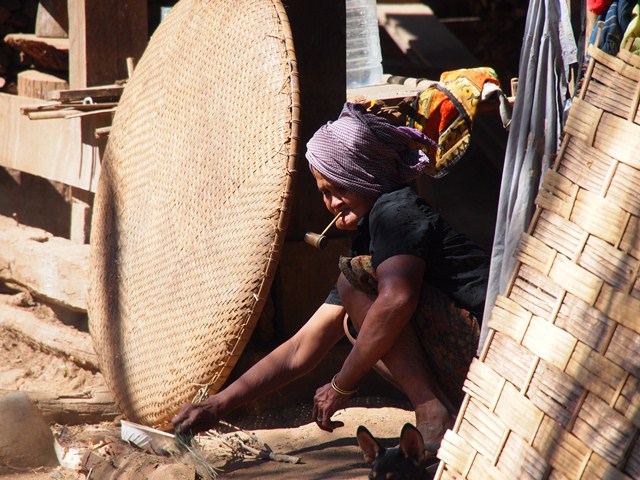 a woman sitting outside smoking a cigarette