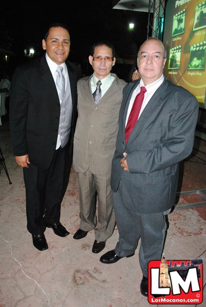 three men in suits and ties pose for a picture